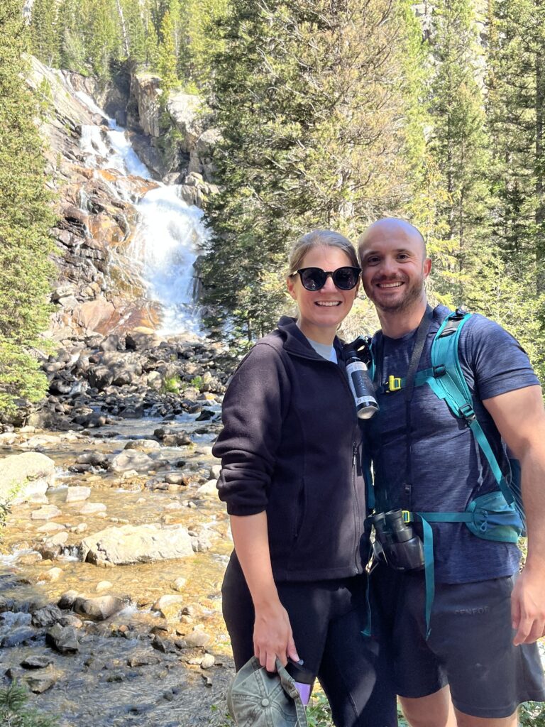 My husband and I posing in front of the Hidden Falls