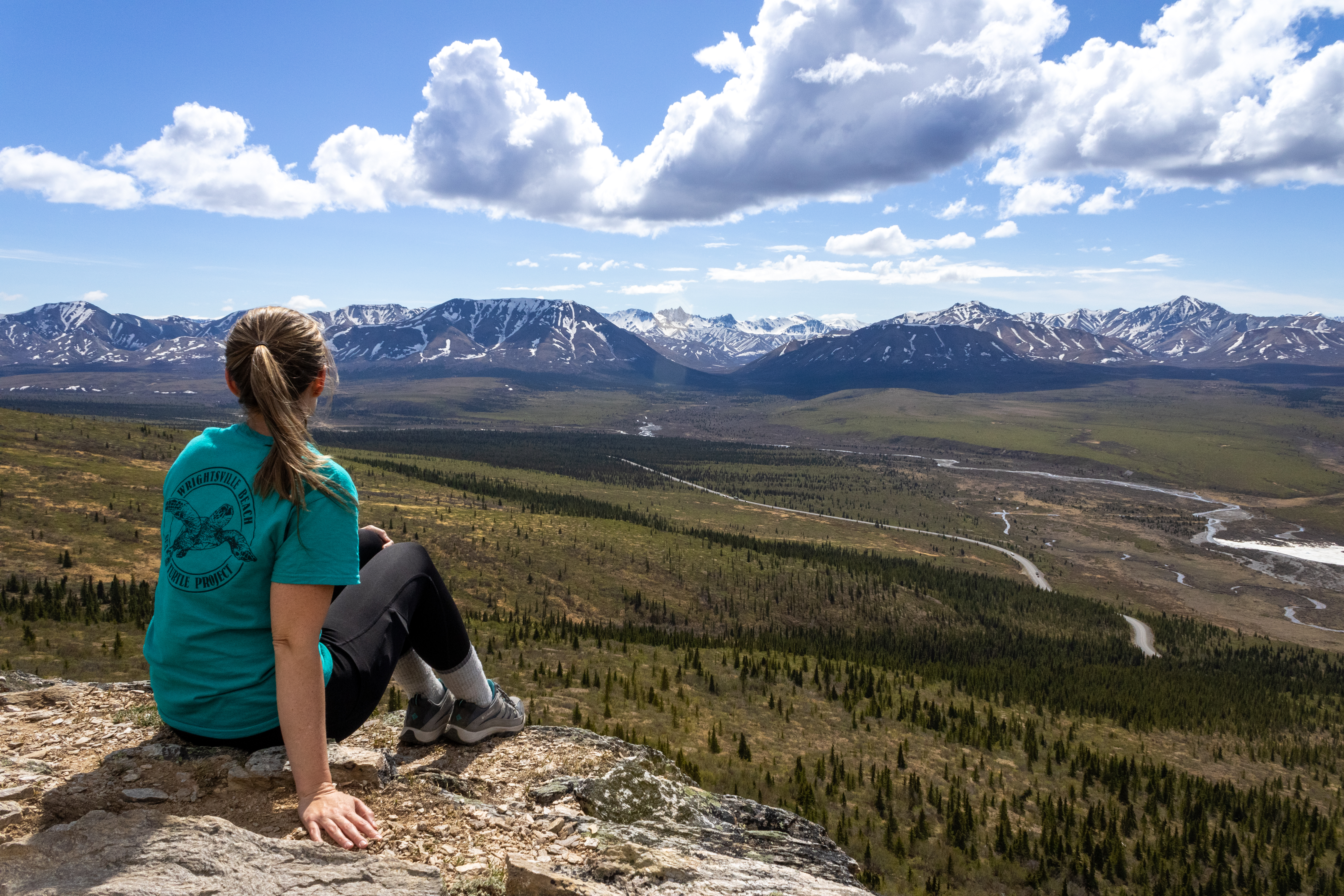 A photo of me overlooking the vastness of Denali National Park from the peak of the savage river hiking trail