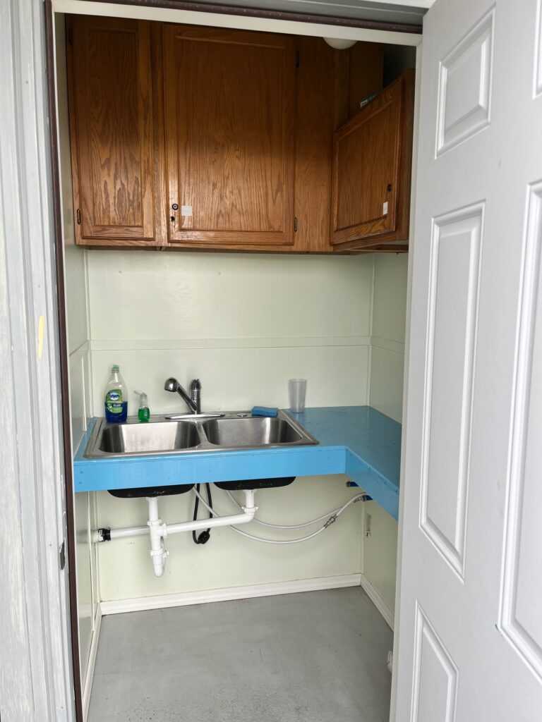 A lovely dishwashing station equipped with soap and sponges for campers use