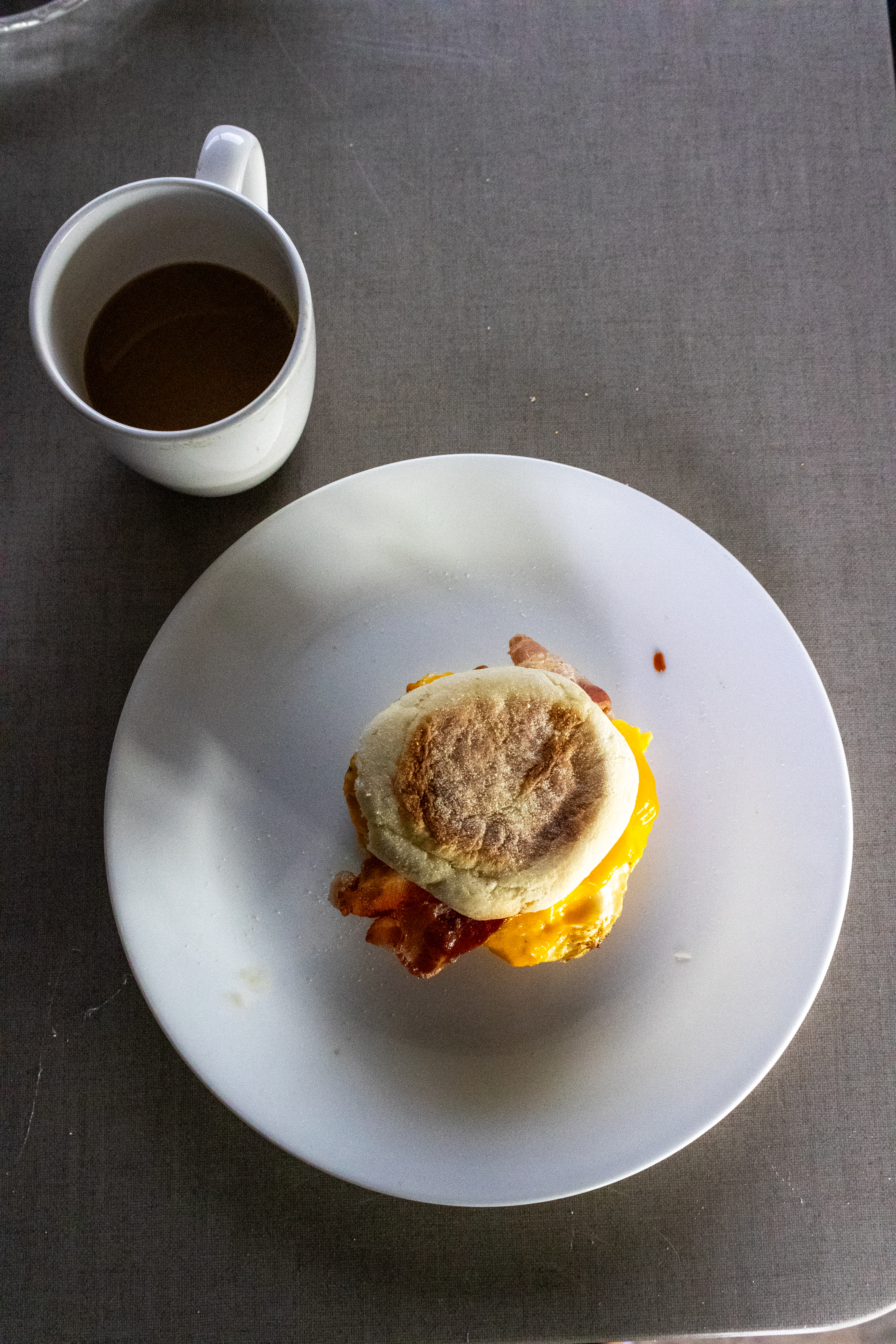 Bacon, egg and cheese breakfast sandwich with coffee